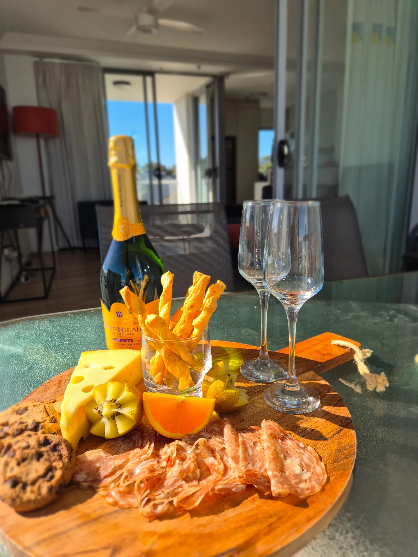 Balcony table with champagne and grazing board