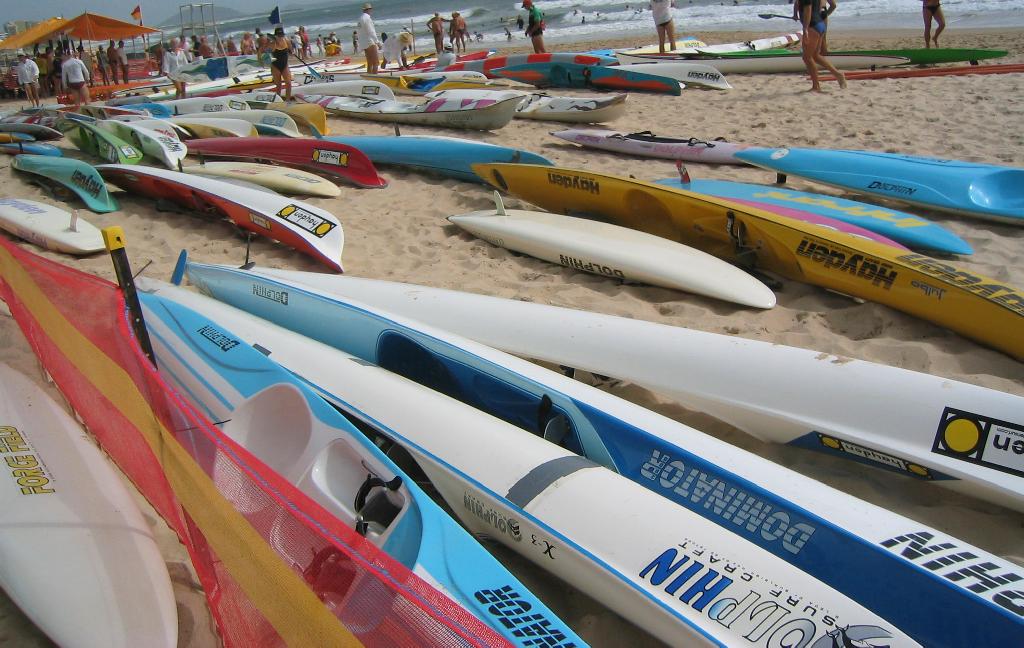 Surf skis lined up on the sand at an Alexandra Headland surf life saving carnival on the Sunshine Coast